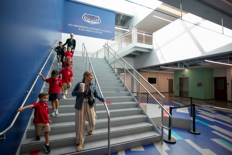 Students and their teachers are shown coming down a stairwell at A.D. Henderson University School