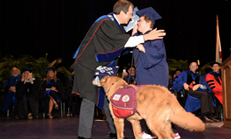 ACI student receives certificate of completion from FAU President John Kelly.