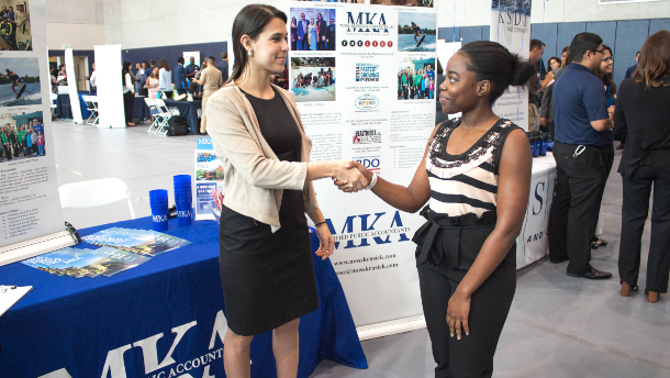 Student and Employer shaking hands at Career fair