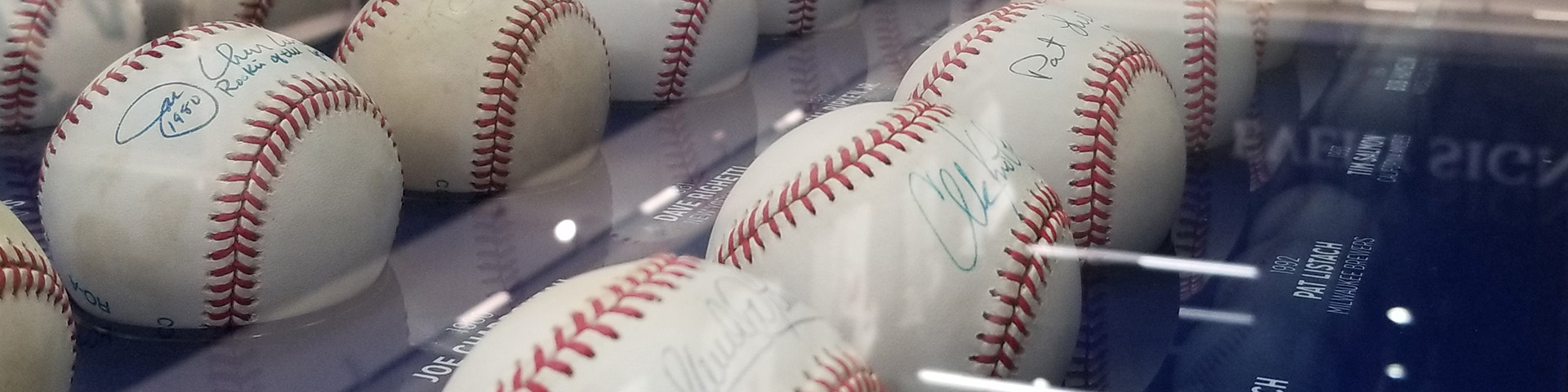 Signed baseballs in an enclosure