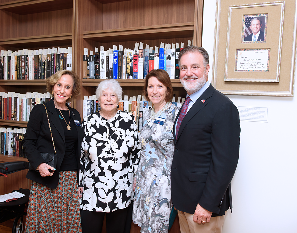 From left, Judith Weiner; FAU benefactor Charna Larkin; Melanie Cabot; and FAU President Adam Hasner in the Alan B. and Charna Larkin American Presidential Study. On the wall, right, is one of the presidential letters signed by former U.S. President George W. Bush.