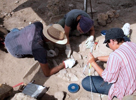3 students in an archaeological dis site