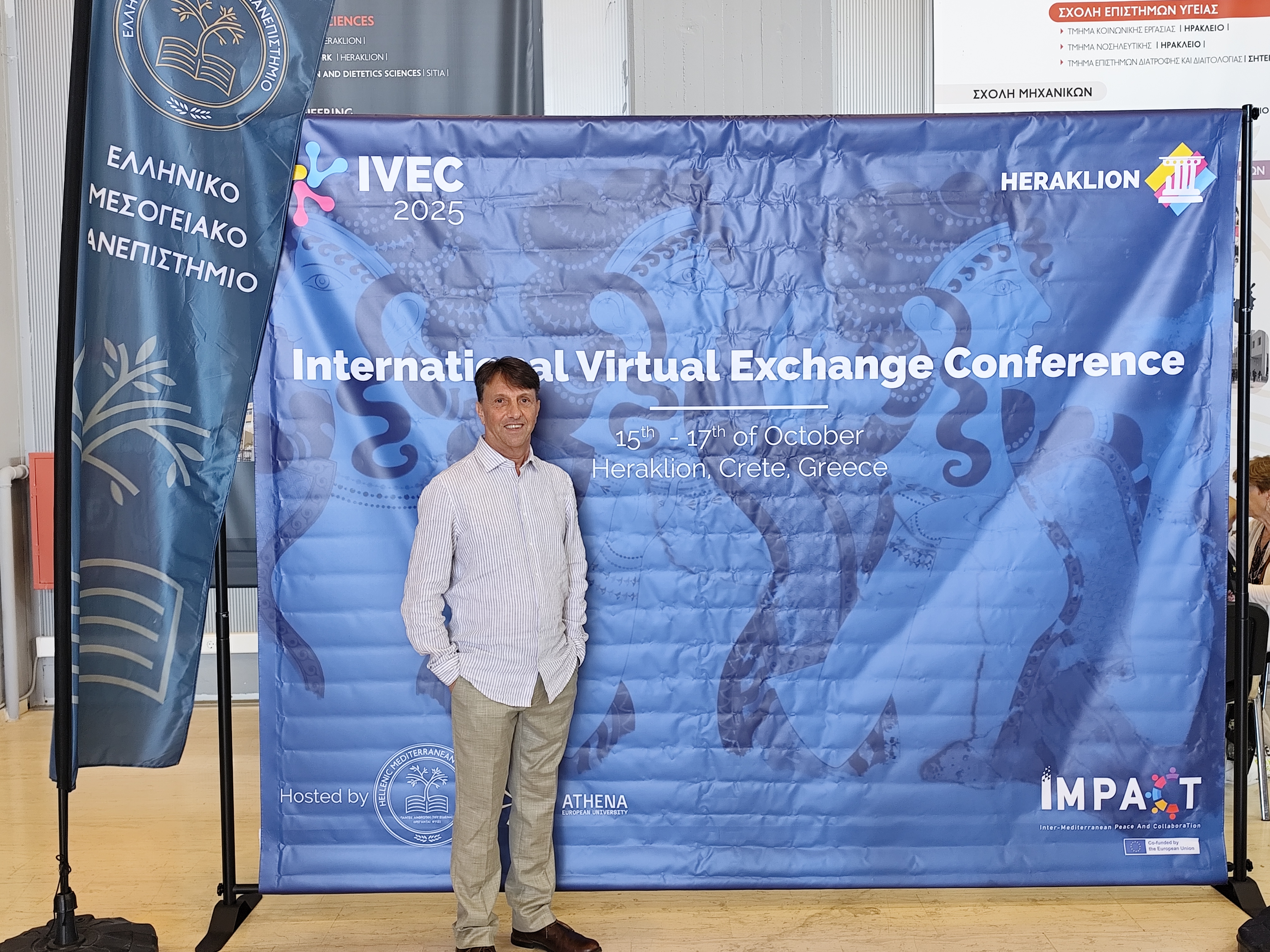 PhD Candidate Jose Luis standing infront of conference poster board.