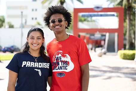 Two students smiling in front of the breezeway