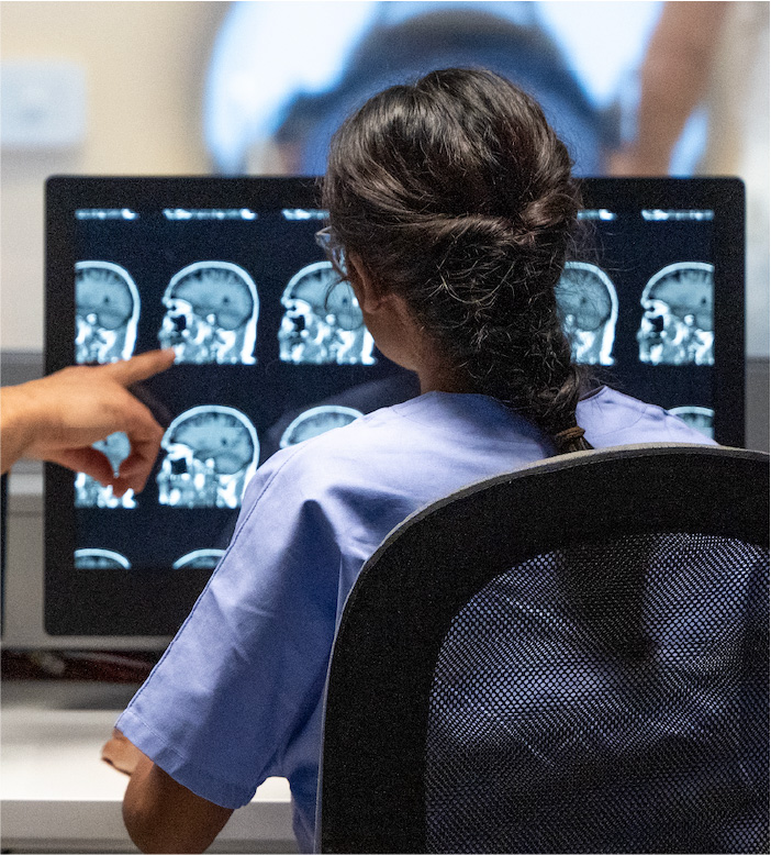 Student in front of brain scan