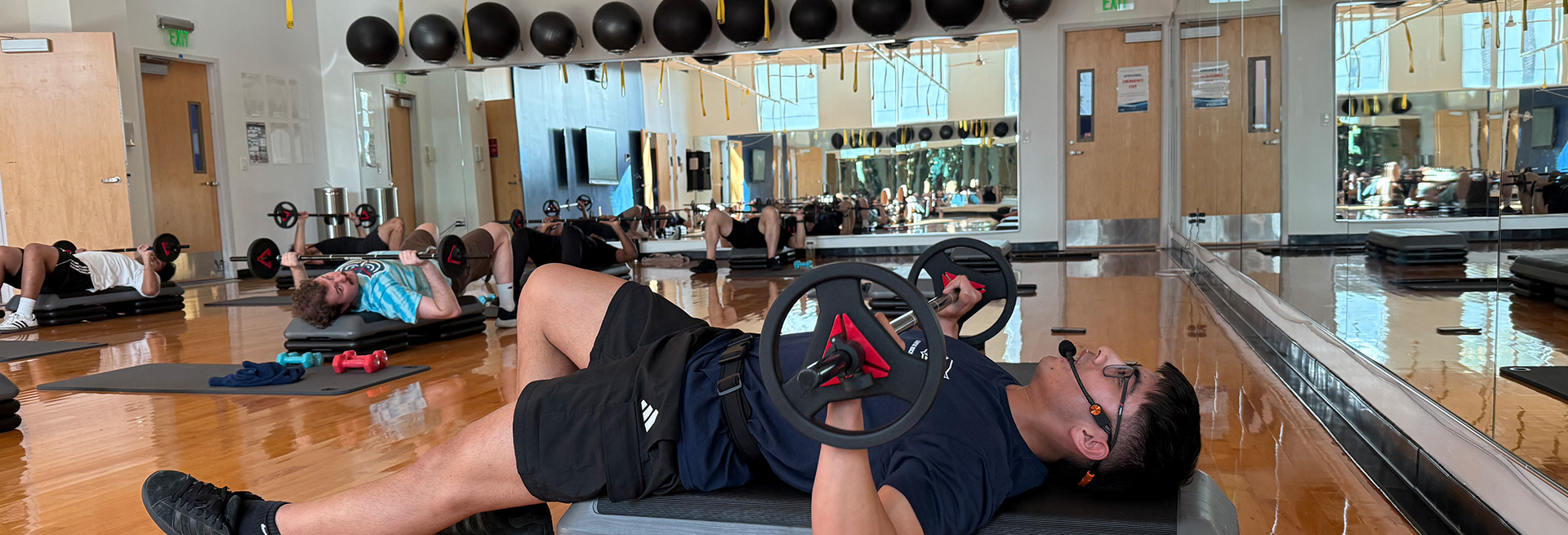 Young fitness instructor conducting class in a studio with headset