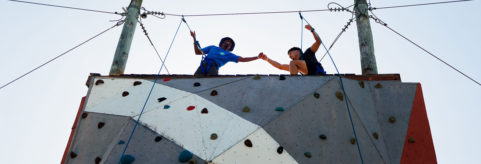Two participants on high ropes challenge course