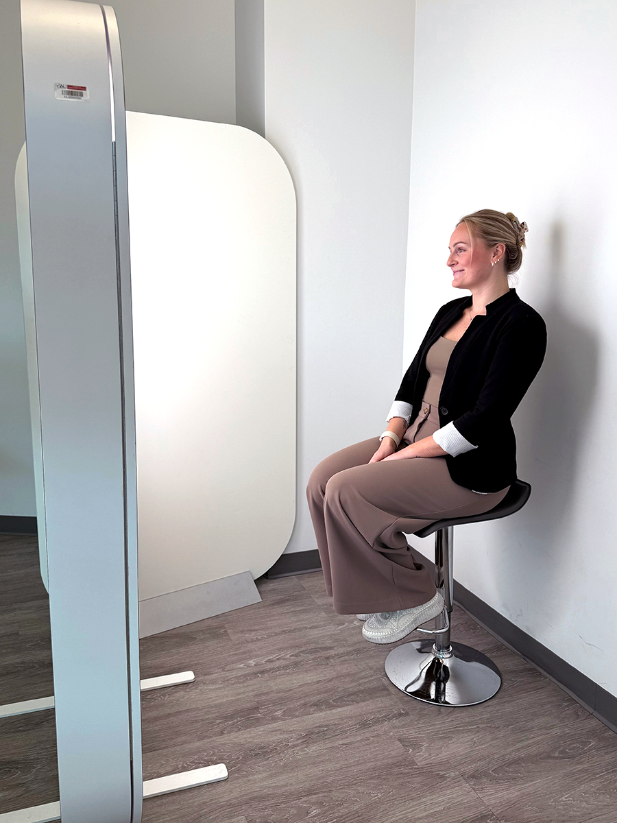 Sitting on a stool looking into the Iris camera