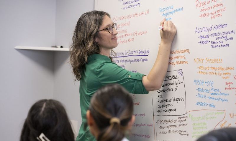 Instructor near a whiteboard