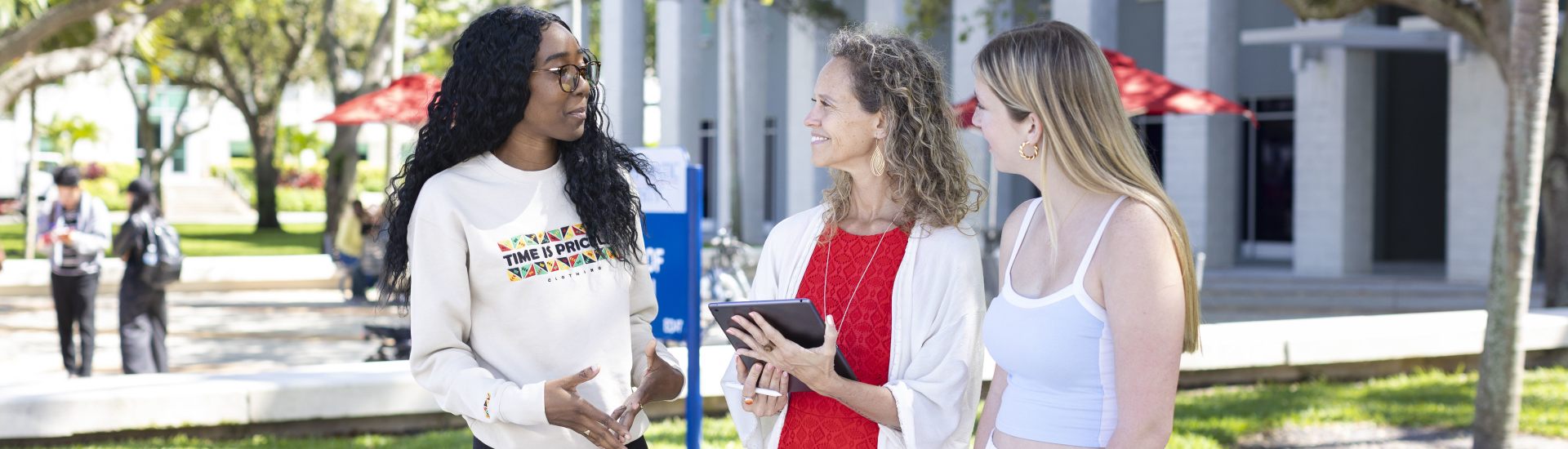 Students chatting outside the College of Education building