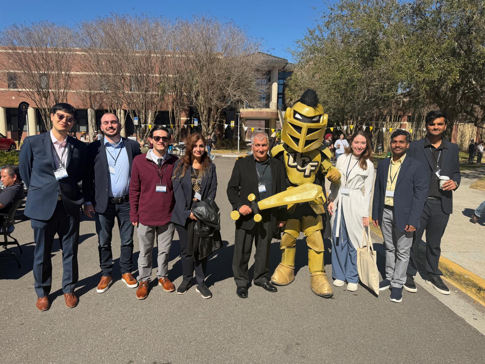 FAU students and faculty with UCF mascot.