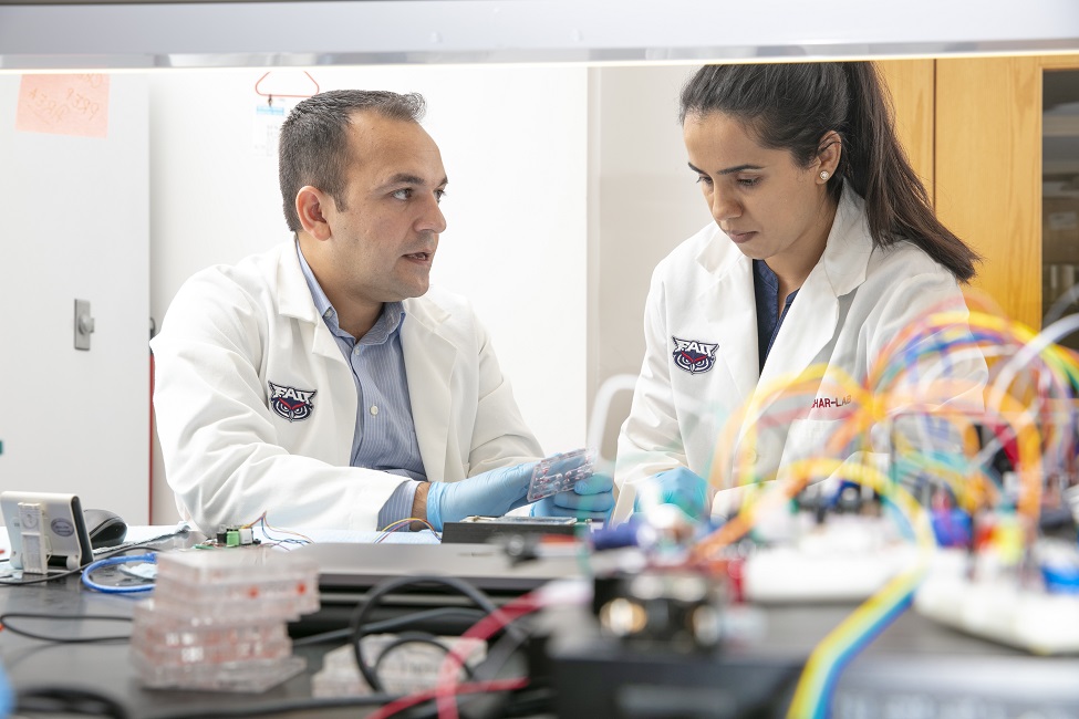 Waseem Asghar, Ph.D., senior author and an associate professor (on the left); and Sandhya Sharma, Ph.D., in the Asghar Laboratory. (Photo by Alex Dolce)