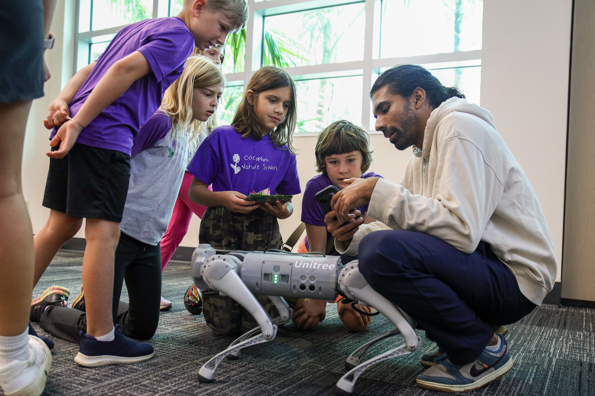 Students participated in an interactive robotics demonstration led by graduate students from the Multimedia Systems Lab (M Lab). During the session, they assisted in coding a robot dog and observed real-time robotic control and interaction systems developed within the lab.