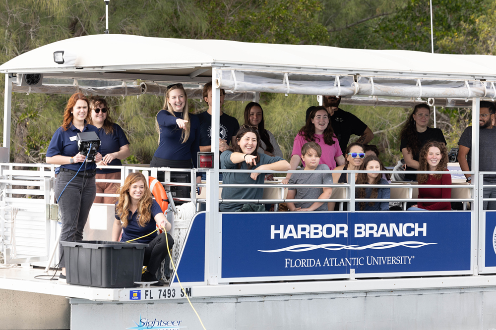 Students are in the Harbor Branch boat pointing at wildlife