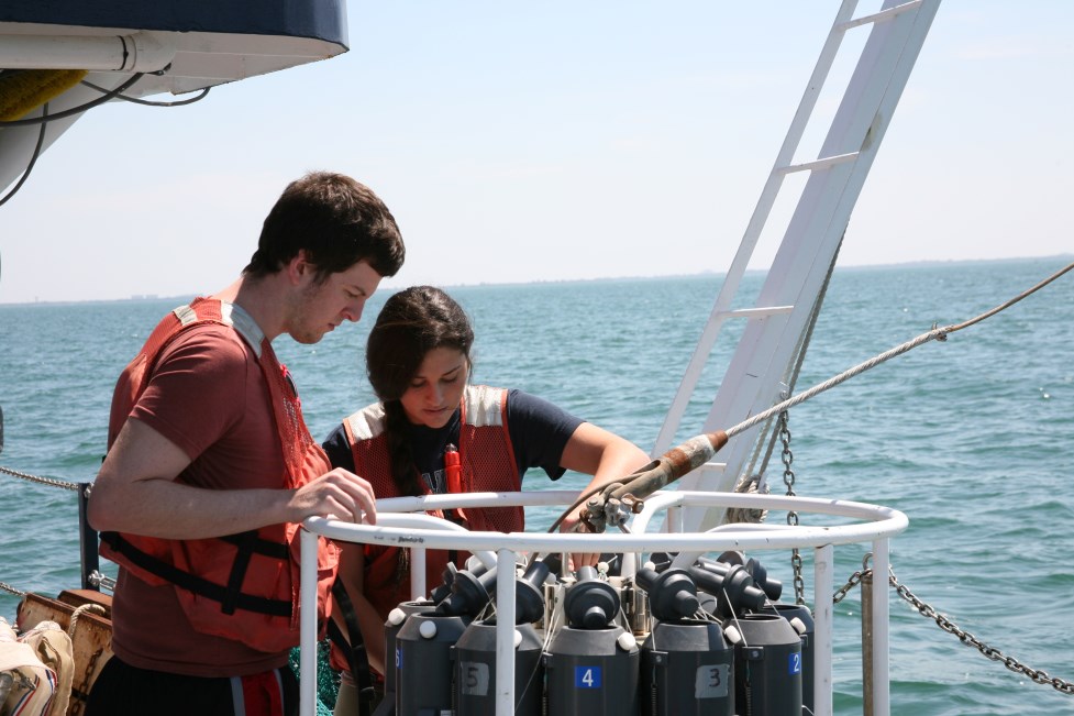 two people looking at machinery on a boat