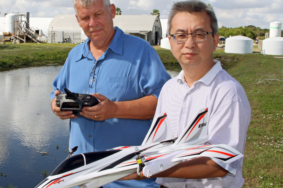 two scientist hold drones