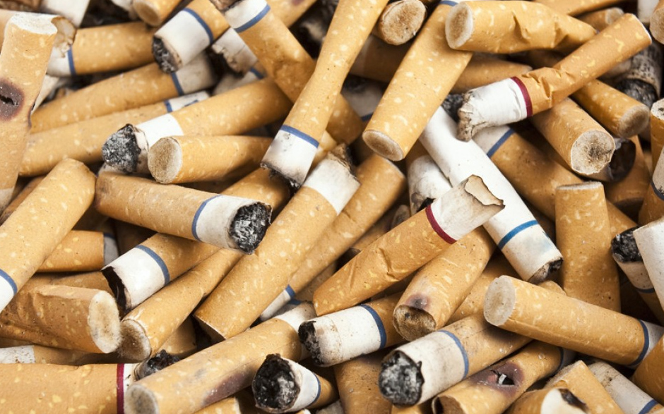 a close-up of a pile of used cigarettes