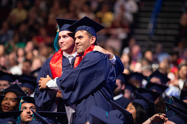 Two male student celebrate at Commencement