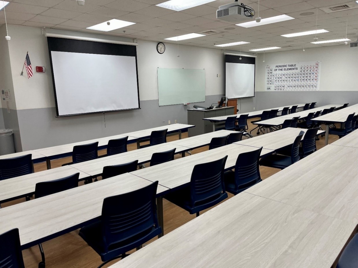 back view of classroom with 50 chairs and 3 windows