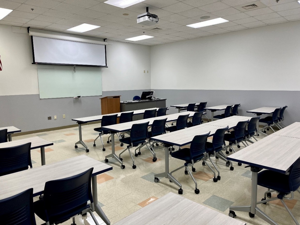 back view of classroom with tables and 32 chairs