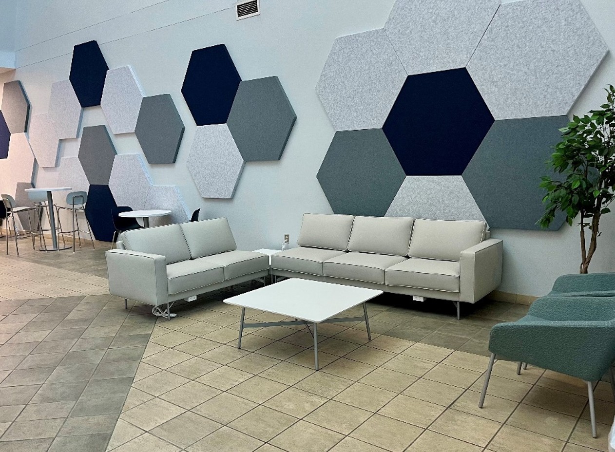 front view of stairs and lobby with chairs and sofas