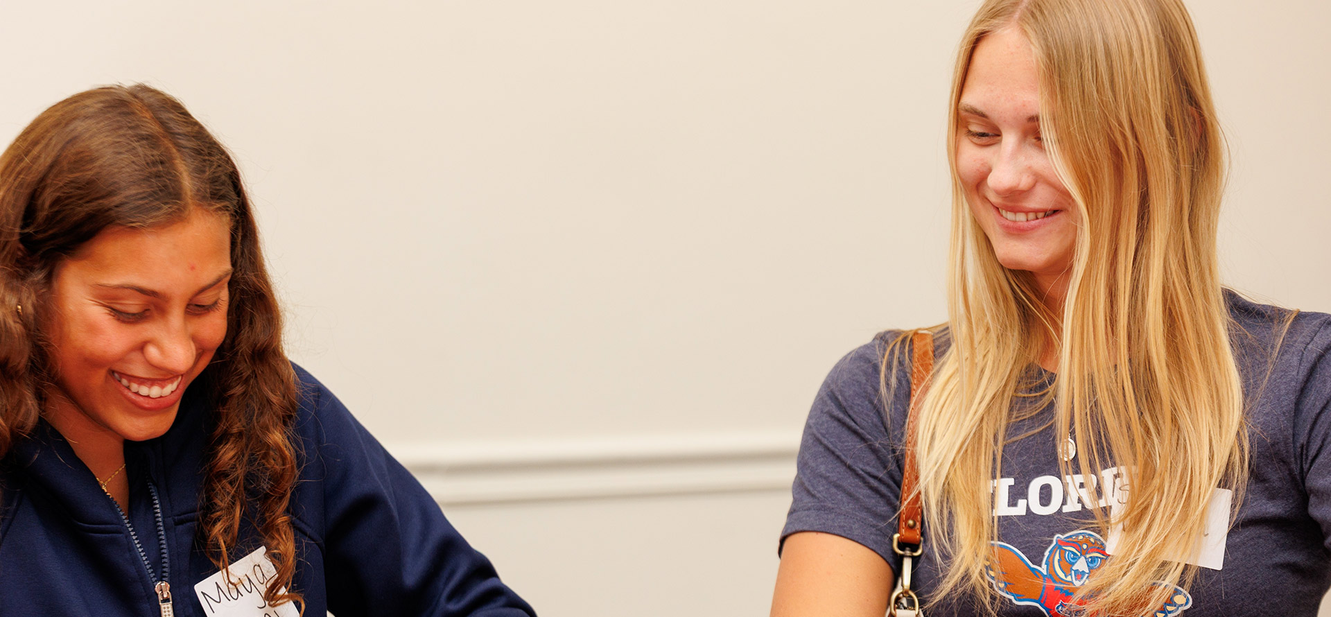 Two student leaders laughing while working