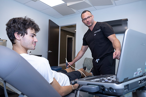 Dr. Collins performing diagnostics on patient
