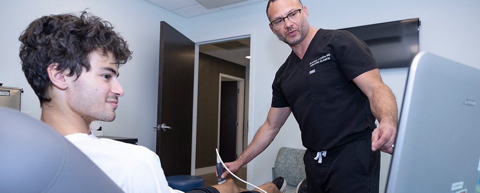 Dr. Collins performing diagnostics on patient's knee