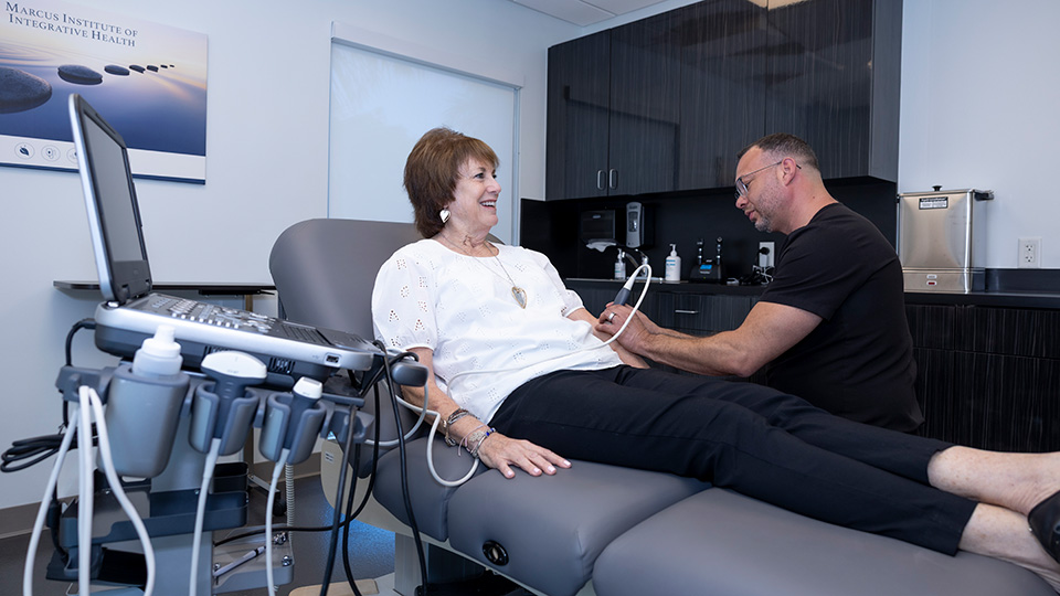 Dr. Collins performing pain management techniques to patient