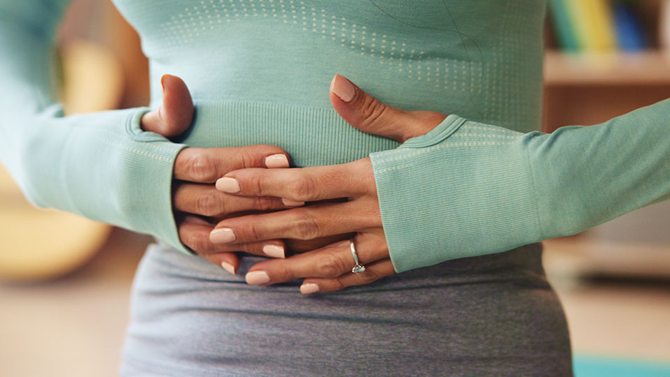 Woman holding her stomach in distress
