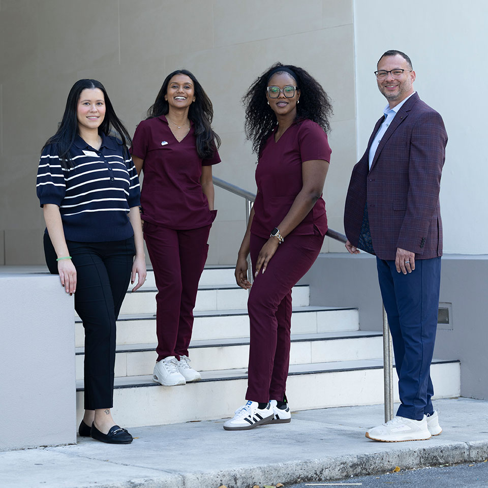 Team members posing in front of the Marcus Institute building
