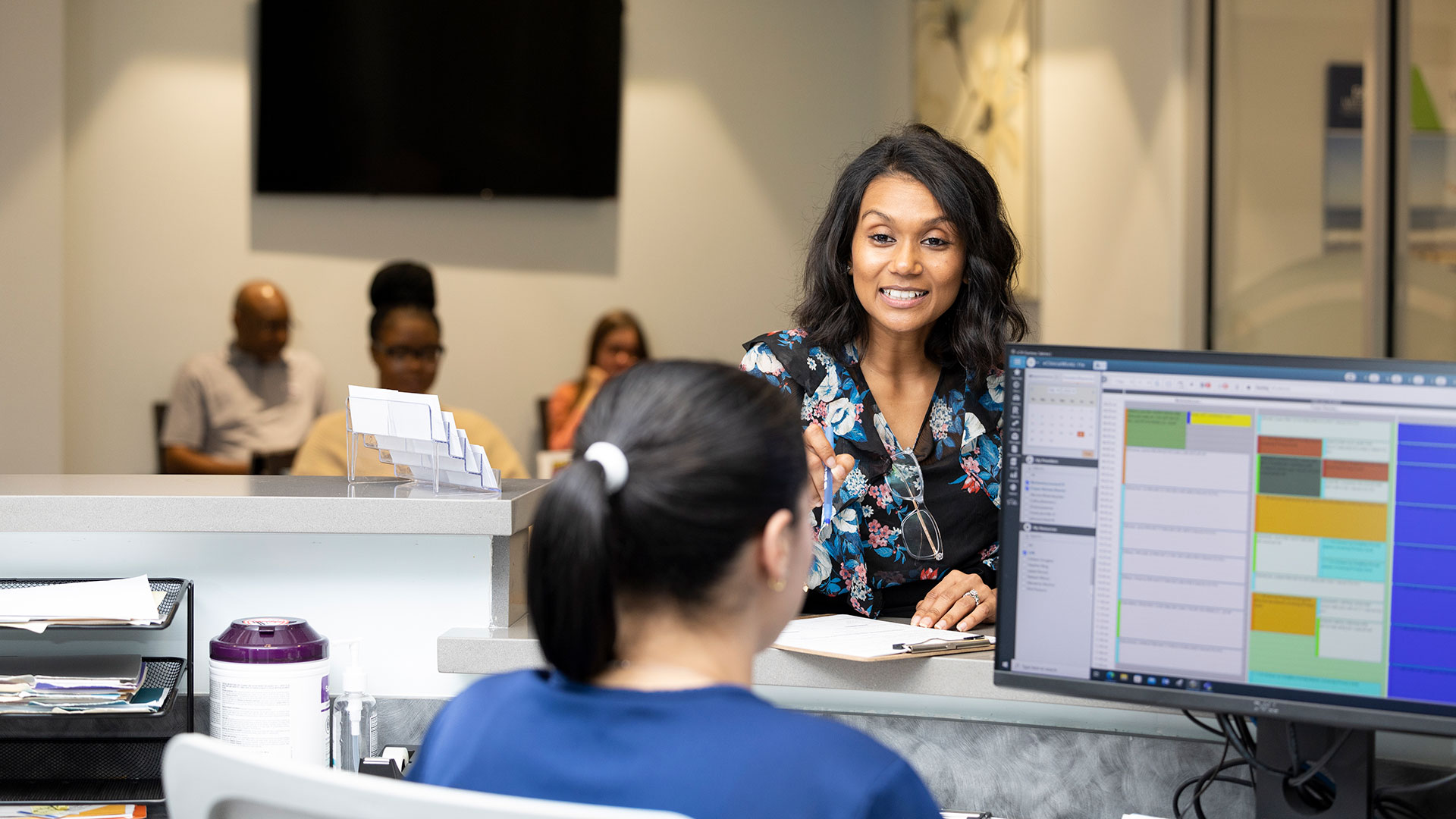 Patient speaking with integrative health office staff member