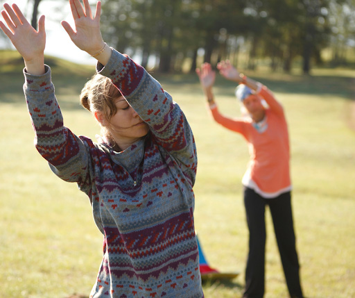 Two women performing tai-chi movements