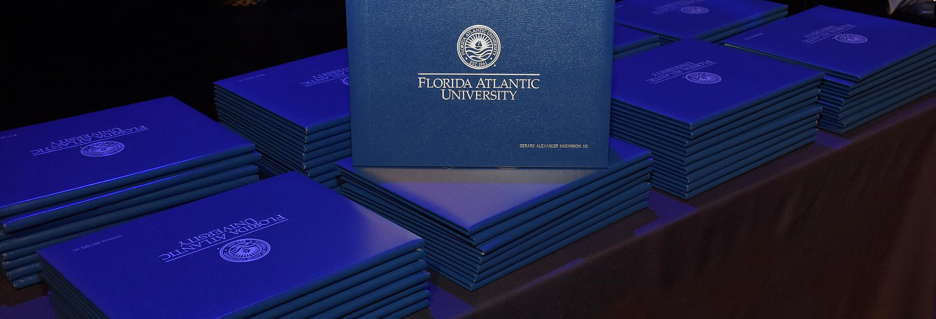 Stack of diplomas on ceremony table
