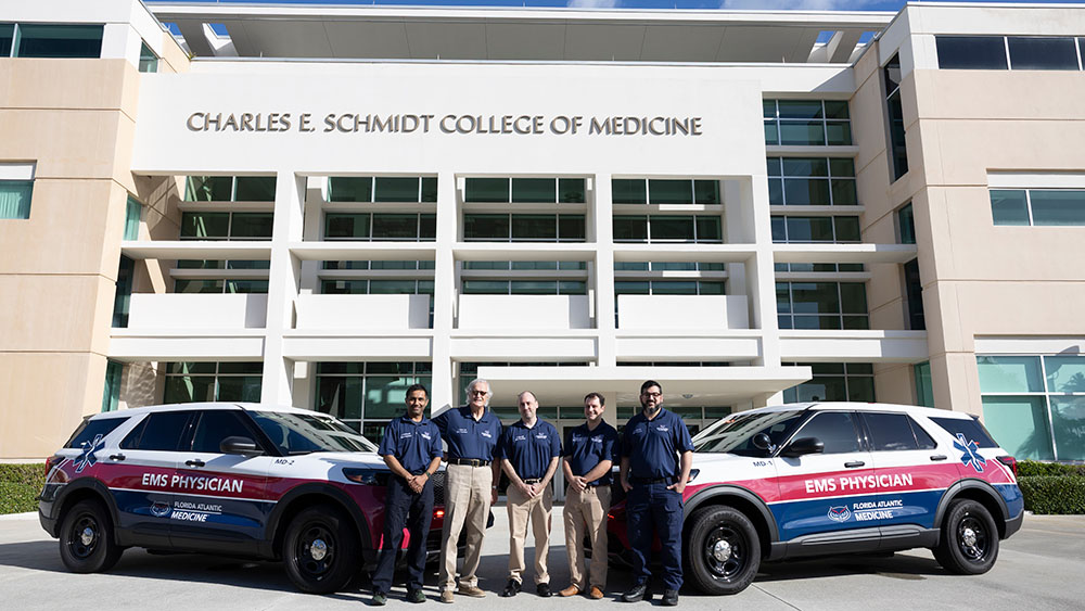 EMS Physicians in front of Schmidt College of Medicine and their emergency vehicles