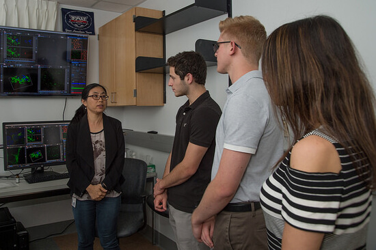 New students receiving a tour of the Schmidt College of Medicine laboratories