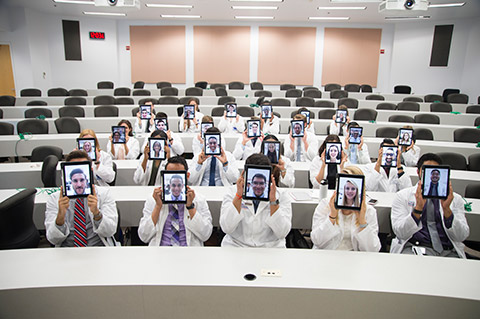 FAU medical students in class holding their iPads