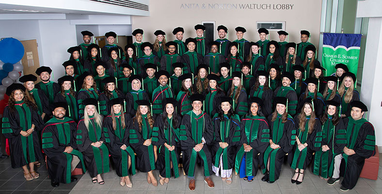 FAU Schmidt College of Medicine graduates taking group picture at 2023 commencement ceremony