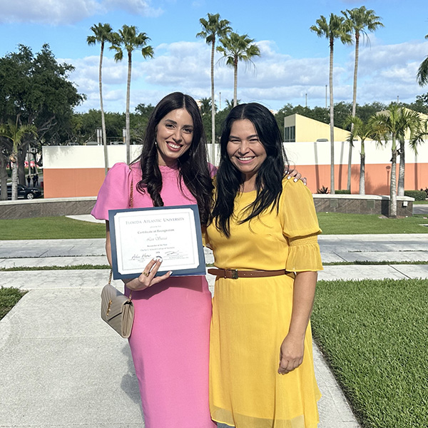 Dr. Sacca and Dr. Mejia with award outside ceremony building on FAU Boca Raton campus