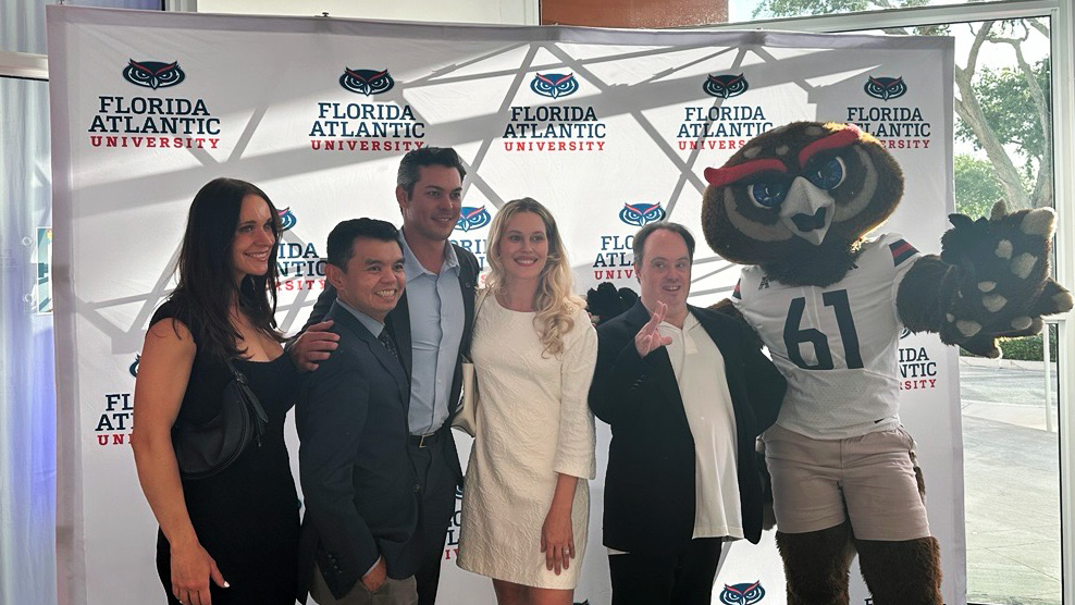 Jaclyn Klimczak with family and friends, along with Owlsley, at the FAU Hall of Fame and Distinguished Alumni Award Ceremony