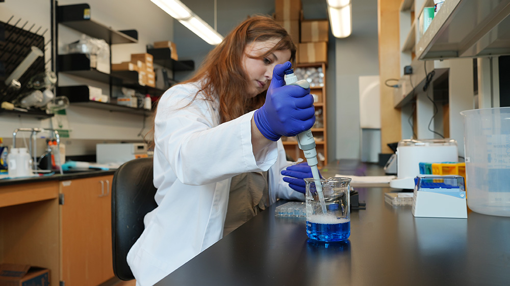Anna Cook performing lab experiment