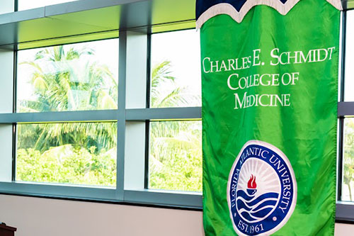 FAU Schmidt College of Medicine banner hanging inside of atrium entrance