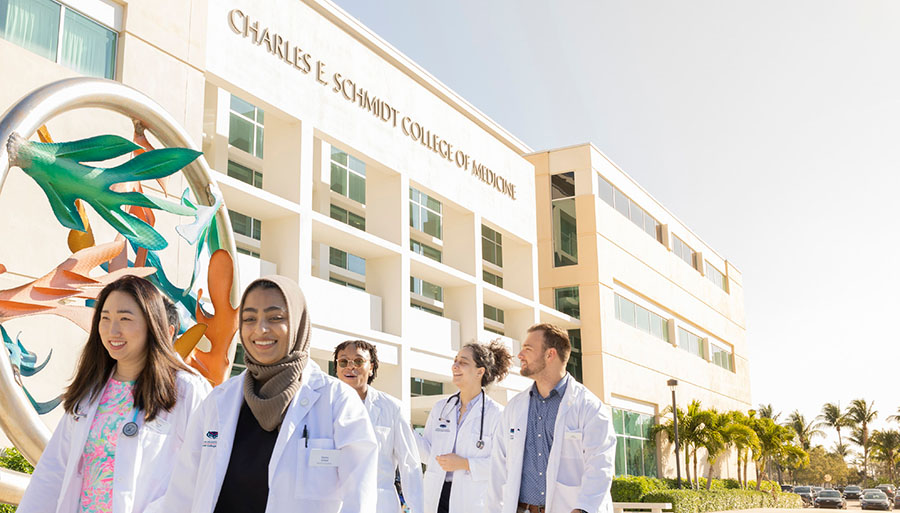 FAU MD students walking in front of the Schmidt College of Medicine building in Boca Raton
