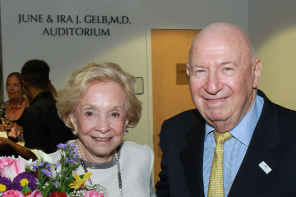 June and Ira Gelb in front of the June and Ira Gelb Auditorium