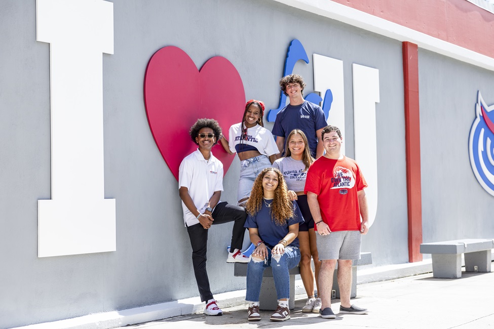 Students smiling in front of I love FAU sign