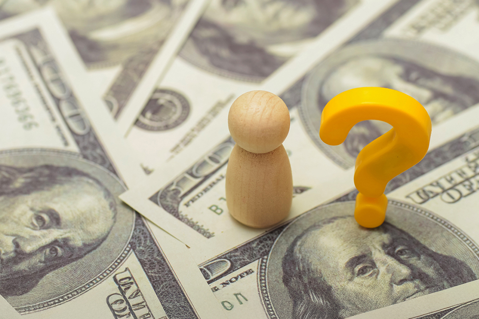 A graphic of dollars and a question mark