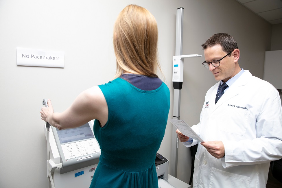 Richard Isaacson, M.D., measures a patient’s percentage of body fat and muscle mass over time to evaluate response to therapies and help refine exercise and nutrition plans. (Photo by Alex Dolce)