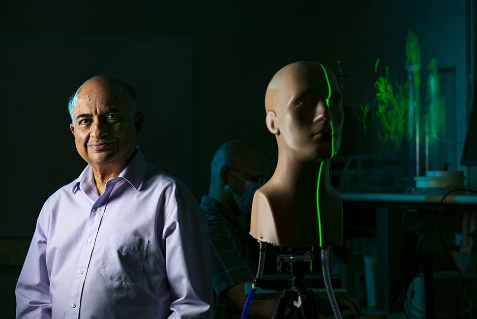 Professor next to a mannequin being scanned