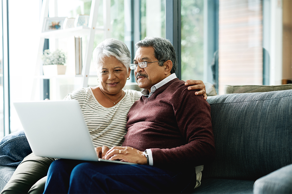 Elder couple taking a class on a laptop