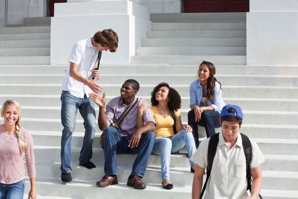 Students on campus greet one another